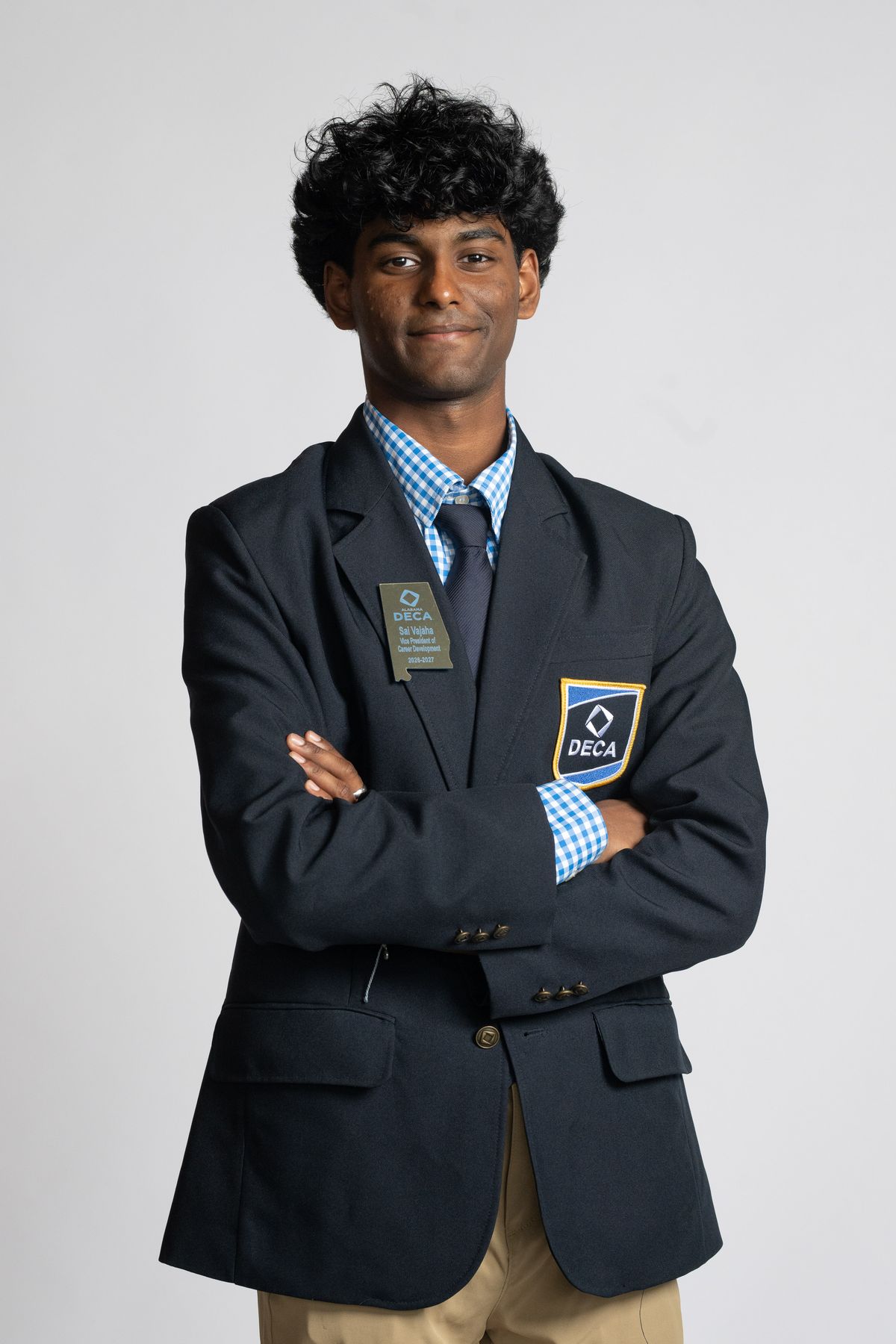 Sai Vajaha in a navy blazer, arms crossed